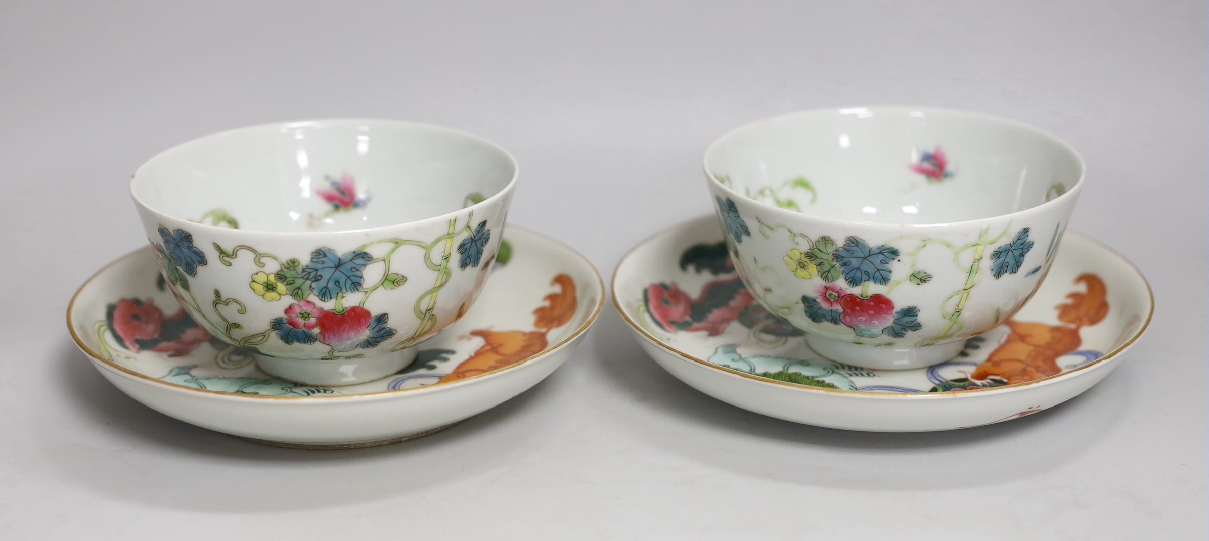 A pair of Chinese famille rose bowls and two similar saucer dishes